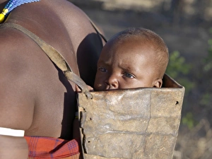 Datoga baby on his mothers back Datoga baby on his mothers back