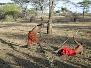 Two Datoga men participate in a mock stick fight Two Datoga men participate in a mock stick fight