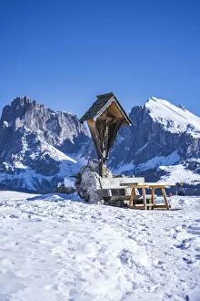 Alpe Di Siusi Collection: Dolomites Alps, snow landscape with clear blue sky. pic nic bench, mountains in background