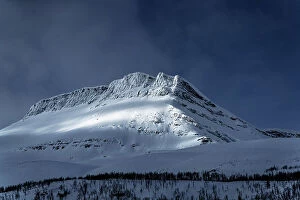 Q3 2023 Collection: Dramatic sky over majestic mountain peak covered with snow, Lyngen Alps, Tromso