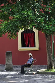 Elderly man sat in Plaza at Iglesia de la Merced, Comayagua, Central America, Honduras Elderly man sat in Plaza at Iglesia de la Merced, Comayagua, Central America, Honduras