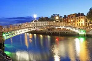 Images Dated 10th October 2017: Europe, Dublin, Ireland, Halfpenny bridge reflecting on the Liffey river by night
