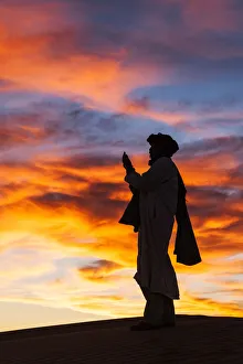 Evening prayer, Sahara desert, Erg Chebbi, Morocco Evening prayer, Sahara desert, Erg Chebbi, Morocco