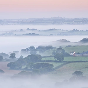 Farmhouse and mist covered countryside, Stockleigh Pomeroy, Devon, England. Autumn Farmhouse and mist covered countryside, Stockleigh Pomeroy, Devon, England. Autumn