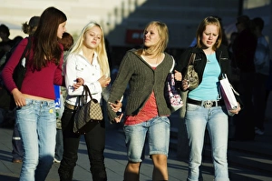 Fashionable Young Girls Walking down Street Fashionable Young Girls Walking down Street