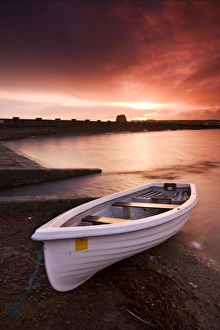 Fishing boat tethered on the shores of the Usk Reservoir at sunrise, Brecon Beacons National Park Fishing boat tethered on the shores of the Usk Reservoir at sunrise, Brecon Beacons National Park