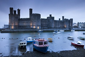 Foreboding evening skies above the immense Caernarfon Castle, Caernarfon, Gwynedd, North Wales Foreboding evening skies above the immense Caernarfon Castle, Caernarfon, Gwynedd, North Wales