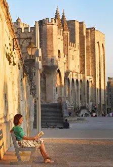 France, Provence, Avignon, Palais de Papes, Woman reading book on bench MR France, Provence, Avignon, Palais de Papes, Woman reading book on bench MR