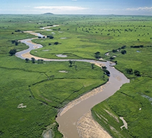 The Garamba River winds it way through the grasslands of the Garamba National Park in The Garamba River winds it way through the grasslands of the Garamba National Park in