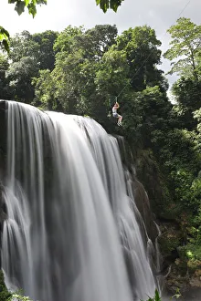 Girl on zip line over waterfall, Cascadas Pulhapanzak, Waterfalls, Honduras .MR Girl on zip line over waterfall, Cascadas Pulhapanzak, Waterfalls, Honduras .MR