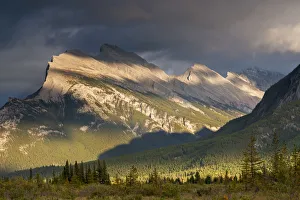 Gorgeous rich evening sunlight bathes against the towering Mount Rundle in the Canadian Gorgeous rich evening sunlight bathes against the towering Mount Rundle in the Canadian