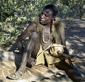 Hadza youth sings to the accompaniment of his two-stringed musical instrument Hadza youth sings to the accompaniment of his two-stringed musical instrument