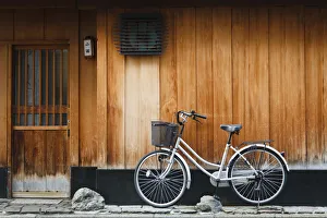 Japan, Chubu Region, Kyoto, Gion. A bicycle rests against the wall of a traditional Japan, Chubu Region, Kyoto, Gion. A bicycle rests against the wall of a traditional