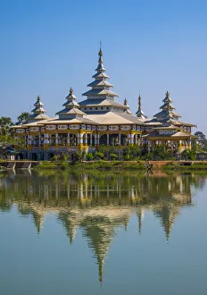 Kyaut Ka Lat Buddhist Temple reflecting in the water of the lake at Hpa-An, Myanmar Kyaut Ka Lat Buddhist Temple reflecting in the water of the lake at Hpa-An, Myanmar