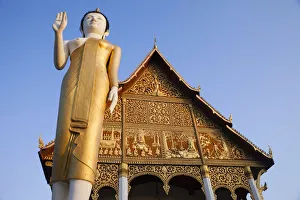 Laos, Vientiane, Pha That Luang, Buddha Statue at Sunrise Laos, Vientiane, Pha That Luang, Buddha Statue at Sunrise