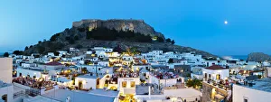 Lindos Acropolis & Rooftop Restaurants illuminated at dusk, Lindos, Rhodes, Greece Lindos Acropolis & Rooftop Restaurants illuminated at dusk, Lindos, Rhodes, Greece