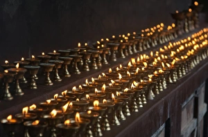 A long line of butter lamps burning at the Changangkha Temple, a fine 15th century temple A long line of butter lamps burning at the Changangkha Temple, a fine 15th century temple