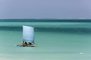 Madagascar, Salary, A pirogue sailing in the blue sea Madagascar, Salary, A pirogue sailing in the blue sea