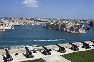 Prints of Malta, Valletta. The cannons of the battery placed high on the defensive wall of Valletta protect the entrance to the Grand Harbour and look across towards Vittoriosa Malta Prints: Print of Malta, Valletta: Grand Harbour Defence