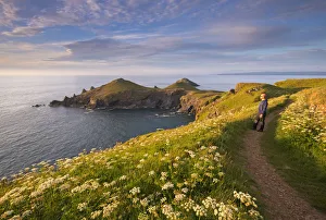 Man appreciating the beautiful coastal view at The Rumps, North Cornwall, England Man appreciating the beautiful coastal view at The Rumps, North Cornwall, England