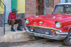 Man and classic American vintage car in Trinidad, Trinidad and Sancti Spiritus Province Man and classic American vintage car in Trinidad, Trinidad and Sancti Spiritus Province