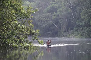 Man in a dugout canoe on the Amazon River, near Puerto Narino, Colombia Man in a dugout canoe on the Amazon River, near Puerto Narino, Colombia