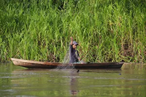 Man fishing on the Amazon River, near Puerto Narino, Colombia Man fishing on the Amazon River, near Puerto Narino, Colombia