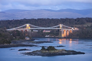 The Menai Bridge spanning the Menai Strait, backed by the mountains of Snowdonia National Park The Menai Bridge spanning the Menai Strait, backed by the mountains of Snowdonia National Park