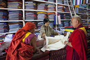 Monks buying cloth in a store in Thimphu, Bhutan Monks buying cloth in a store in Thimphu, Bhutan