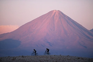 Mountain biking in the Atacama Desert against a backdrop Mountain biking in the Atacama Desert against a backdrop