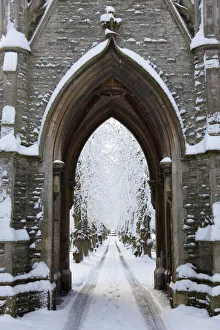 Newark, UK. The central path and victorian gothic lychgate at Newark cemetery Newark, UK. The central path and victorian gothic lychgate at Newark cemetery
