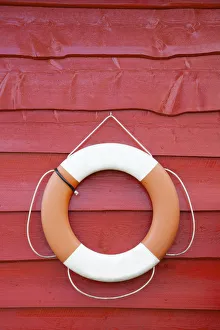 Norway, life belt hanging from traditional wooden shed Norway, life belt hanging from traditional wooden shed