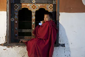 A novice monk near Wangdue Phodrang in Bhutan A novice monk near Wangdue Phodrang in Bhutan