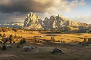 Alpe Di Siusi Collection: Some old cabins lost in the meadows of the Alpe di Siusi (Seiser Alm) during an early autumn sunset