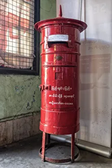 Old colonial style red letterbox in post office in Yangon, Myanmar Old colonial style red letterbox in post office in Yangon, Myanmar
