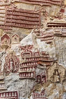 Old temple with Buddhas statues and religious carving on limestone rock in sacred Kaw Old temple with Buddhas statues and religious carving on limestone rock in sacred Kaw