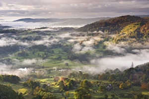 Patches of morning mist float above countryside near the River Brathay, Lake District National Park Patches of morning mist float above countryside near the River Brathay, Lake District National Park