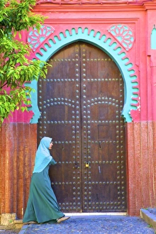 Person Walikng Infront Of Traditional Moroccan Decorative Door, Tangier, Morocco Person Walikng Infront Of Traditional Moroccan Decorative Door, Tangier, Morocco