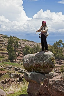 Peru, A Quechua-speaking man plays his flute on Taquile Island. The 7-sq-km island has a population of around Peru, A Quechua-speaking man plays his flute on Taquile Island. The 7-sq-km island has a population of around