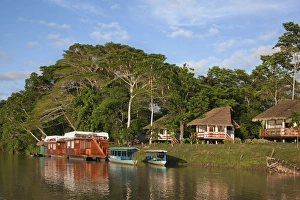Peru. A tourist Lodge and two houseboats on the banks of the Madre de Dios River Peru. A tourist Lodge and two houseboats on the banks of the Madre de Dios River