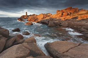 Pink Granite coast, Brittany, France. The Ploumanach lighthouse (Men Ruz) an sunset Pink Granite coast, Brittany, France. The Ploumanach lighthouse (Men Ruz) an sunset