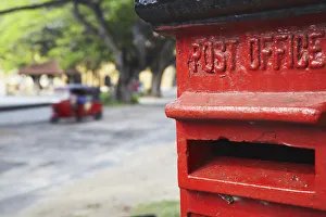 Red post box with tuk tuk in background, Galle, Sri Lanka Red post box with tuk tuk in background, Galle, Sri Lanka