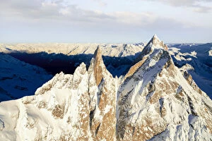 Rock Face Collection: Rock pinnacles of Ago Di Sciora and Pioda Di Sciora peaks at sunrise, aerial view, Val Bregaglia