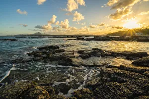 Rocks washed by the Indian Ocean lit by sunset, Trou d'Eau Douce, Flacq district Rocks washed by the Indian Ocean lit by sunset, Trou d'Eau Douce, Flacq district