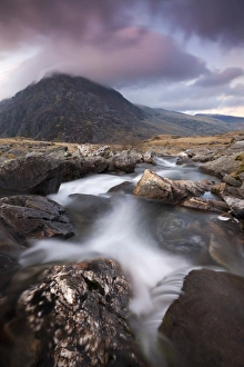 Rocky river in Cwm Idwal leading to Pen yr Ole Wen Mountain at sunset, Snowdonia National Park Rocky river in Cwm Idwal leading to Pen yr Ole Wen Mountain at sunset, Snowdonia National Park