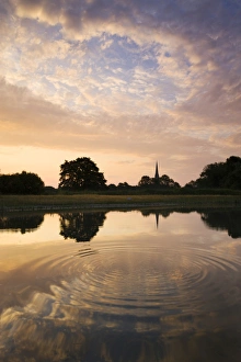 Salisbury Cathedral Spire and a beautiful dawn sky reflected in a rippled pond, Salisbury Salisbury Cathedral Spire and a beautiful dawn sky reflected in a rippled pond, Salisbury