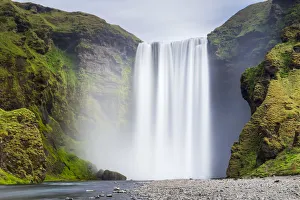Scenic view of Skogafoss waterfall on cliff, South Iceland, Iceland Scenic view of Skogafoss waterfall on cliff, South Iceland, Iceland