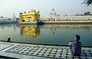 A Sikh pilgrim pauses for reflection by Amrit Sarovar A Sikh pilgrim pauses for reflection by Amrit Sarovar