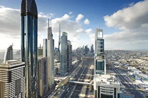 Skyscrapers along Sheikh Zayed Road looking towards the Burj Kalifa, Dubai, United Skyscrapers along Sheikh Zayed Road looking towards the Burj Kalifa, Dubai, United