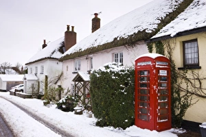 Snow covered cottages and traditional phone box in the village of Morchard Bishop Snow covered cottages and traditional phone box in the village of Morchard Bishop